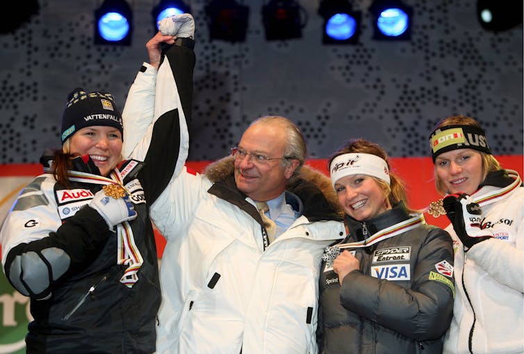Swedish king, Carl Gustav, congratulates medal winners at the 2007 world alpine skiing championships.
