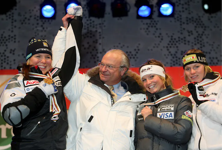 Swedish king, Carl Gustav, congratulates medal winners at the 2007 world alpine skiing championships.