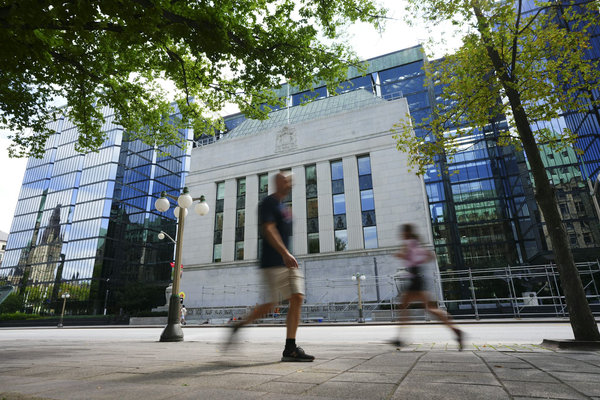 People walk past a building