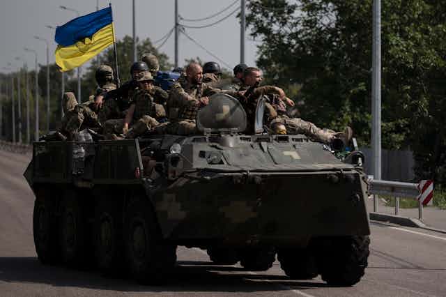Ukrainian soldiers atop a tank
