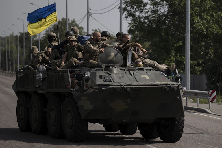Ukrainian soldiers atop a tank
