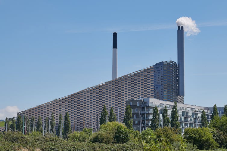 A sloped building with two chimneys.