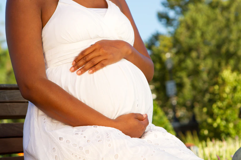 pregnant woman holding belly