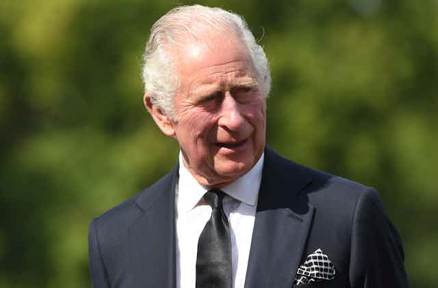 King Charles III in a black suit. 