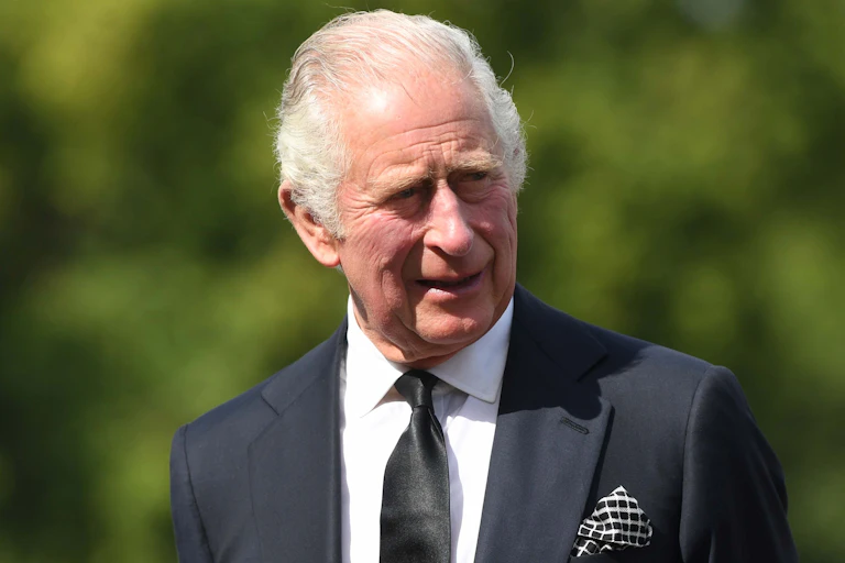 King Charles III in a black suit.
