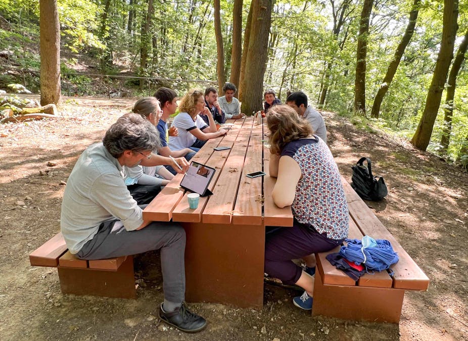 Participants at a Paris-Saclay workshop on educational innovation work on ideas for teaching in a forest.