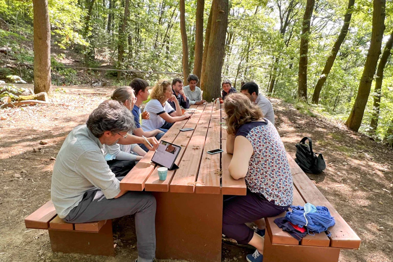 Participants at a Paris-Saclay workshop on educational innovation work on ideas for teaching in a forest.