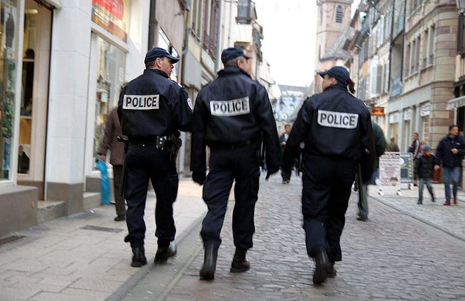 Trois policiers déambulant dans une ville