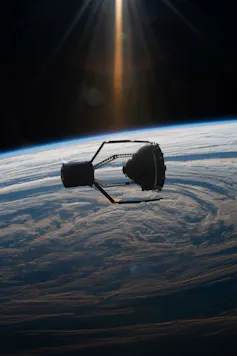 A ClearSpace chaser is designed to use robotic arms to capture space debris.