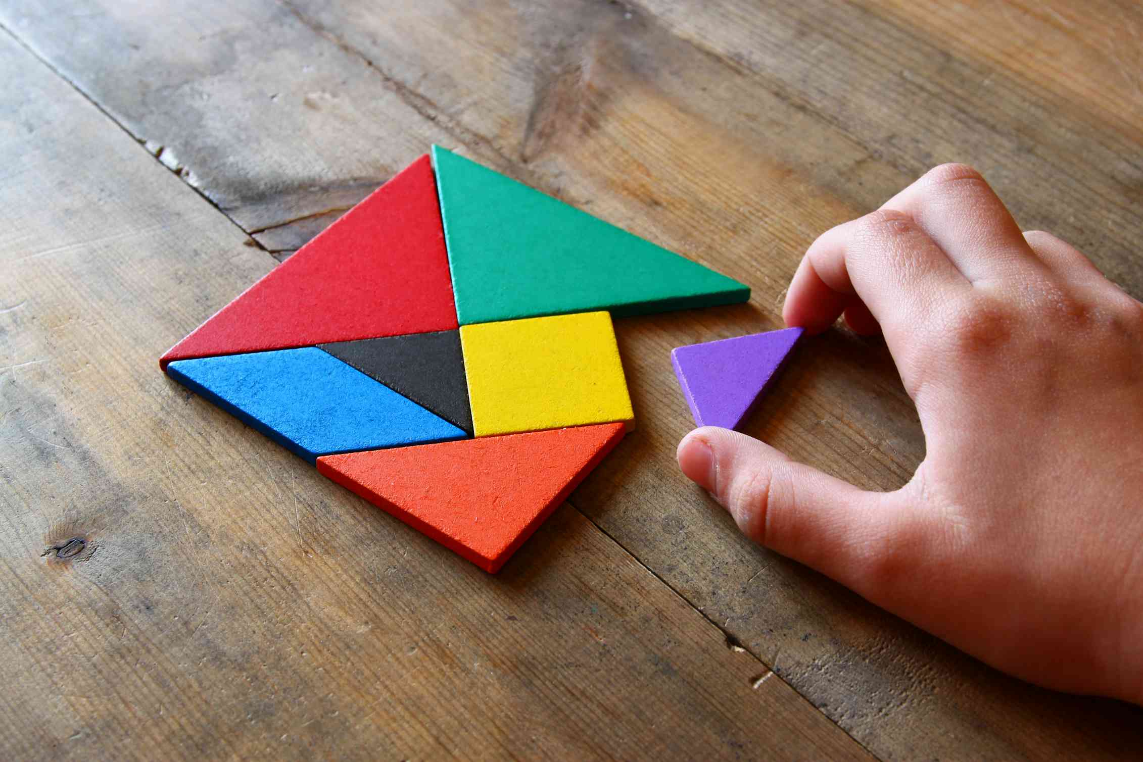 A Tangram puzzle lies on a table.