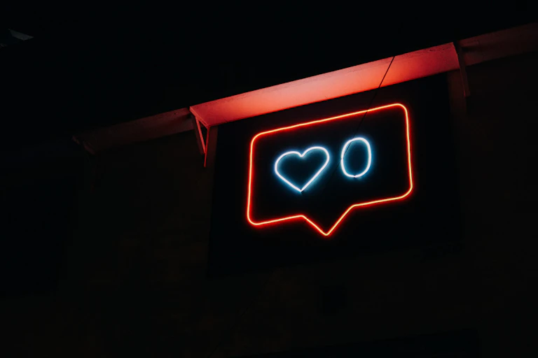 A neon sign with a heart and zero in a speech bubble