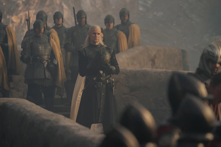 Man in armour with an army on a bridge.