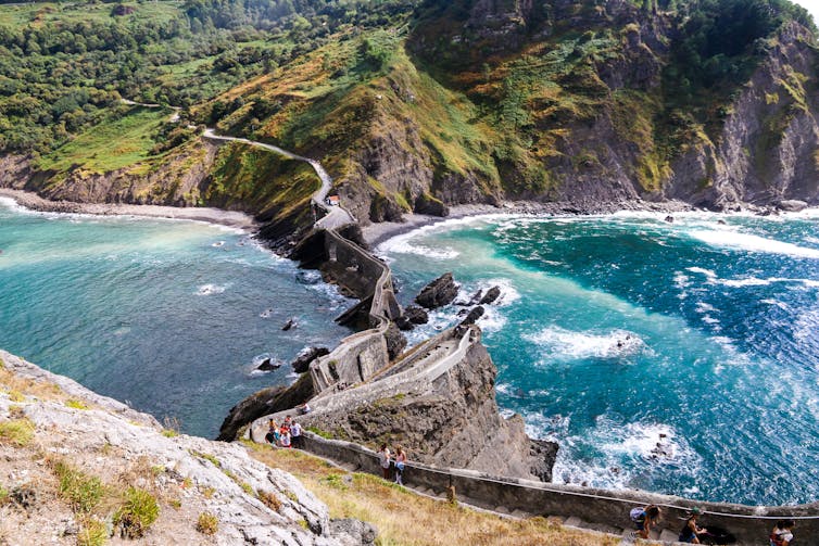 An island with a bridge in the sea.