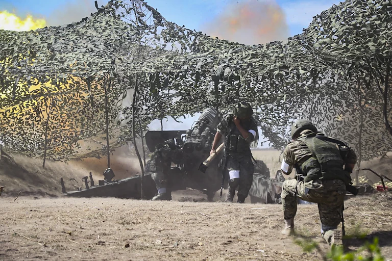 Russian defence ministry handout showing troops manning a field artillery piece in the Kherson region of Ukraine.