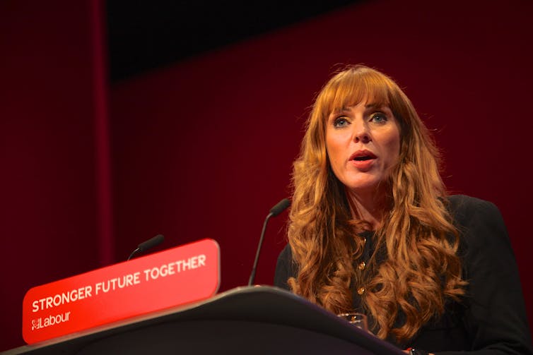 Angela Rayner speaking at a podium with a red placard reading Stronger Future Together, Labour Party
