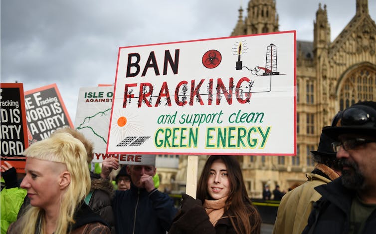 Woman holds 'ban fracking' sign