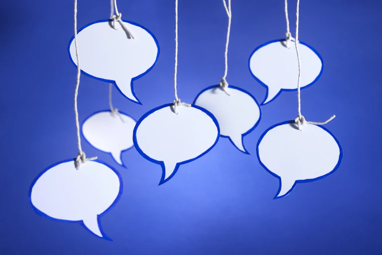 Paper speech bubbles held up with string