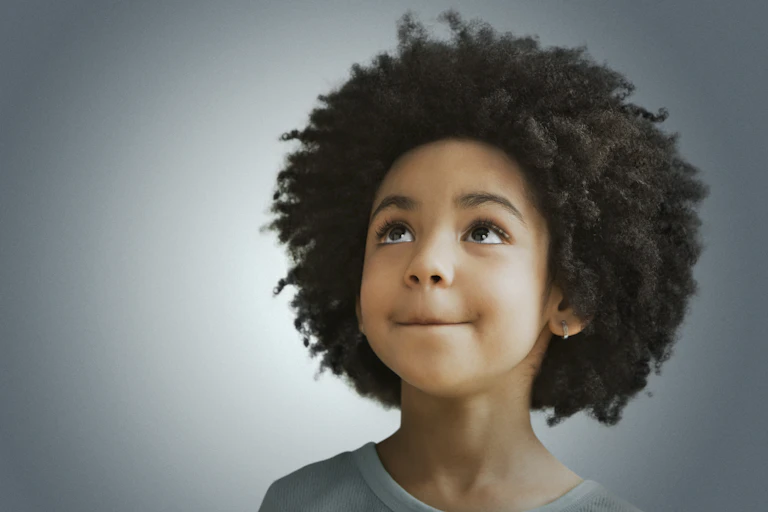 A girl with an afro looks upward against a bluish-gray backdrop with a halo effect.
