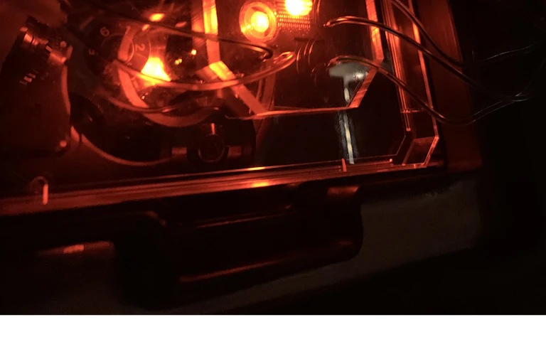 A glowing orange device with tubes going out of it