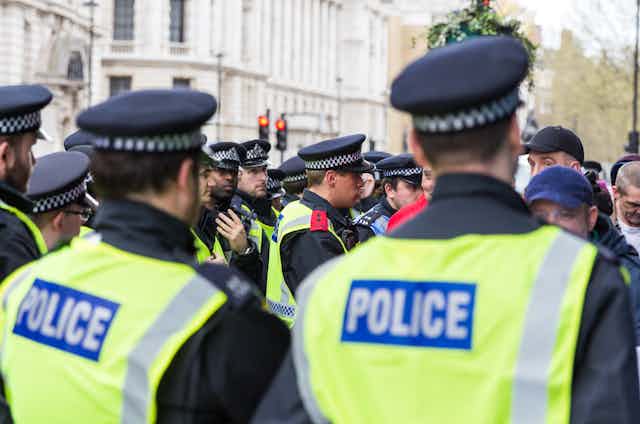 A group of police in London wearing hats and high-vis vests