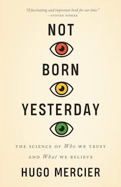 Cover of Not Born Yesterday by Hugo Mercier. Text with three eyes is red, yellow and green.