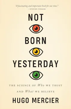 Cover of Not Born Yesterday by Hugo Mercier. Text with three eyes is red, yellow and green.