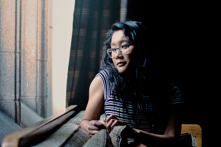 Woman looks out the window