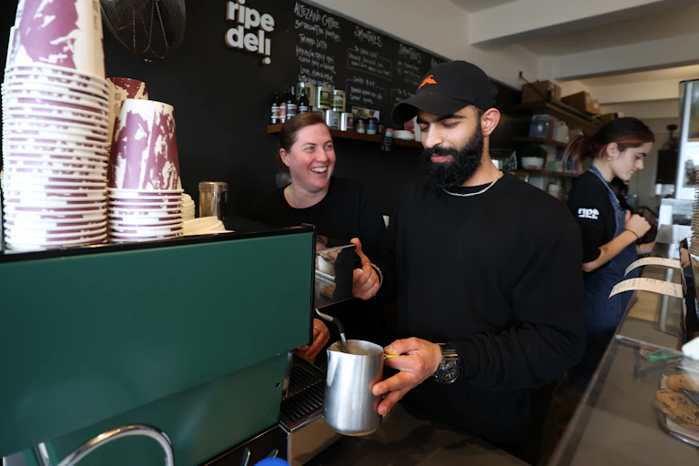 Two people working in a cafe