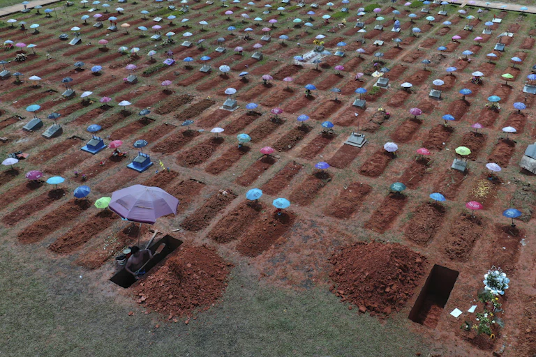 Worker digs graves in Peru to bury people who died of COVID-19