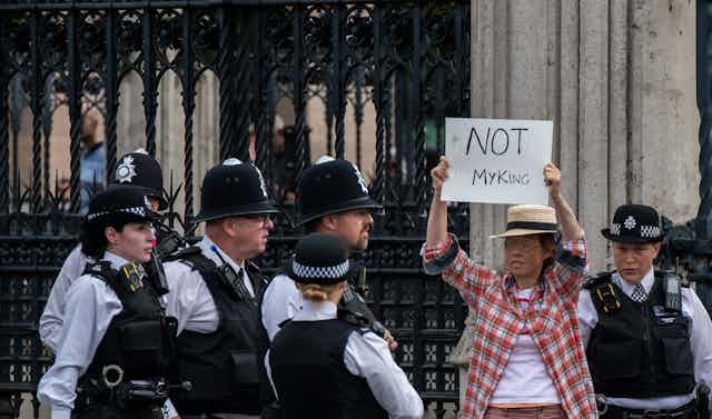 Anti-monarchy protestor being led away from the Palace of Westminster by British police