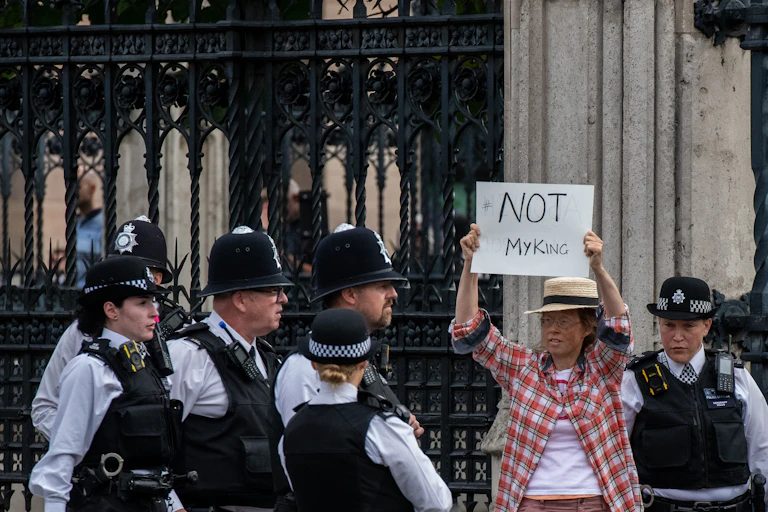 Anti-monarchy protestor being led away from the Palace of Westminster by British police