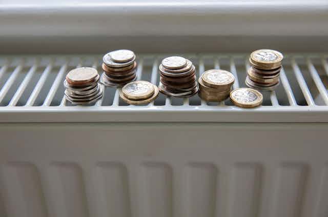 Small piles of coins on a radiator.