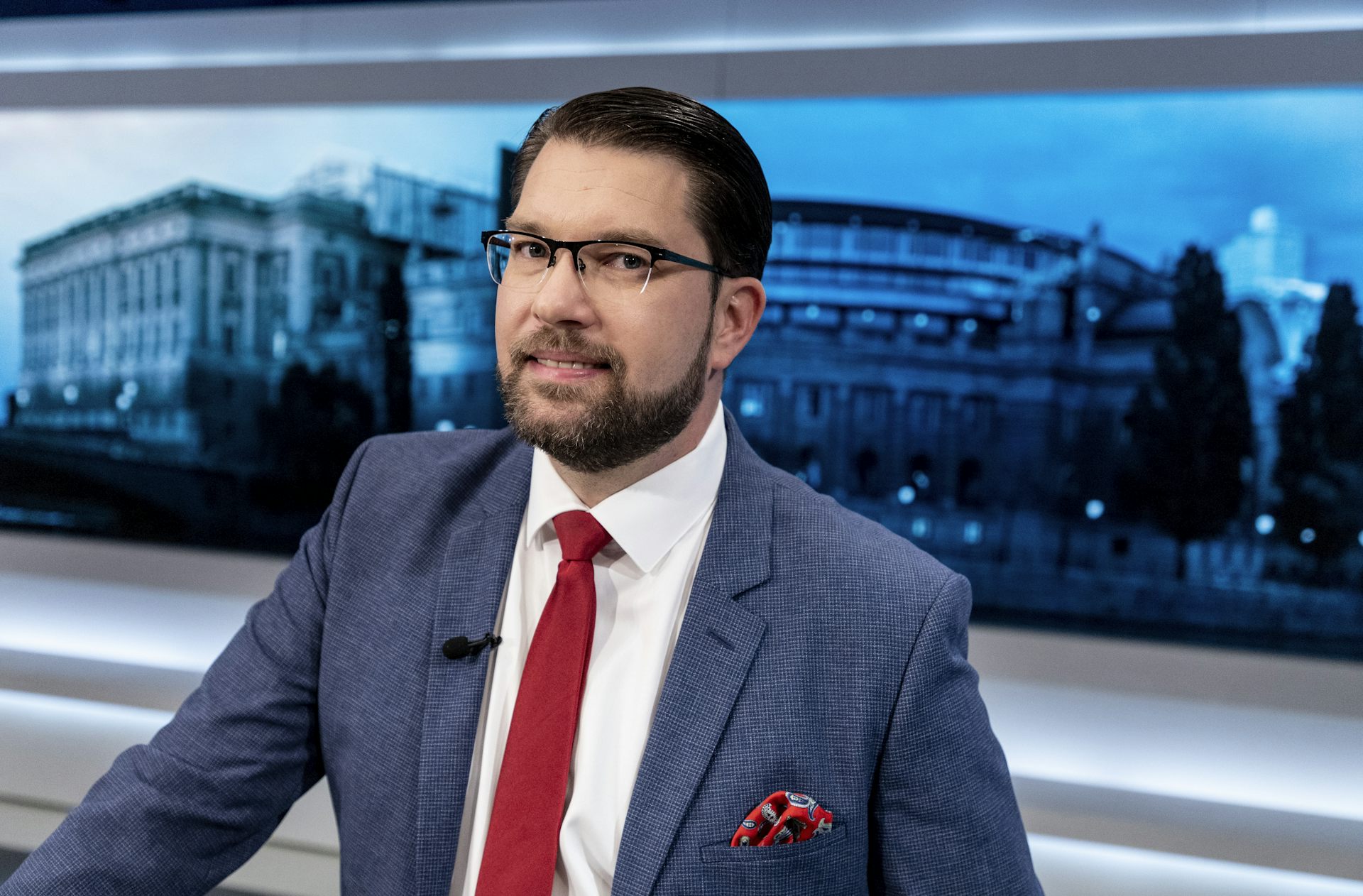 Jimmie Åkesson, leader of the Sweden Democrats, poses for the camera in a TV studio.