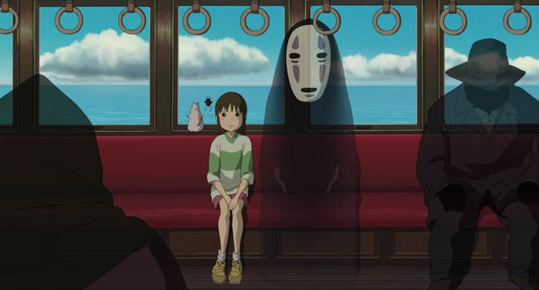 Girl sits on a train next to ghosts.
