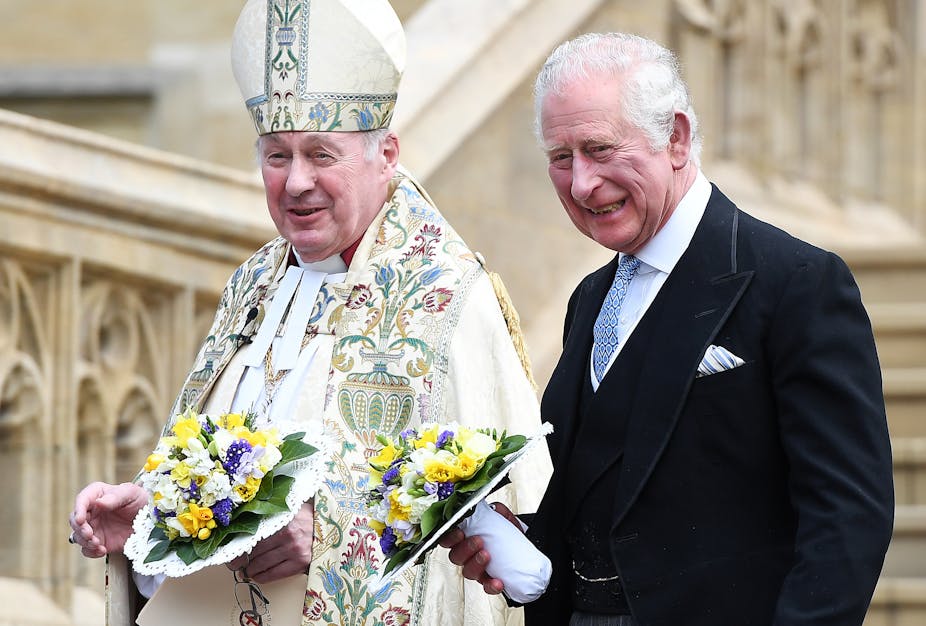 Charles, then Prince of Wales, walks beside an Anglican bishop