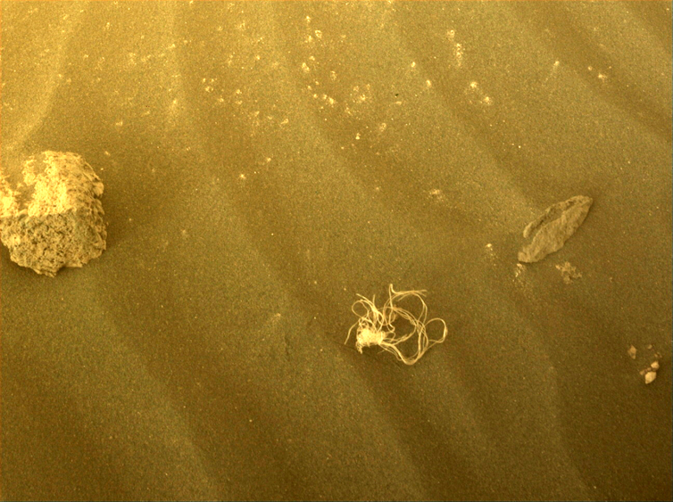 A small tangled piece of netting on the surface of Mars.