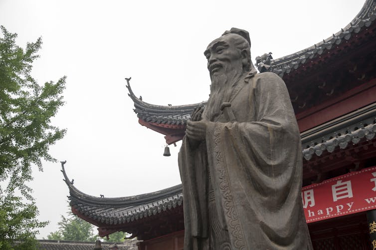 A tall statue of Confucius in Nanjing city in China.