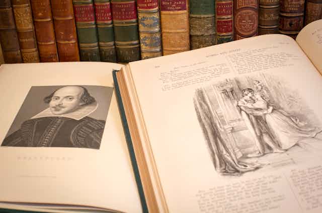 Two books – one with a sketch of William Shakespeare – sit open in front of an array of books that stand alongside one another.