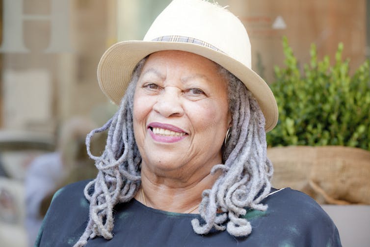 Toni Morrison wears her hair in gray locks under a cream-colored hat.