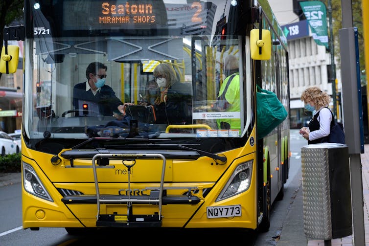 Masked people on a bus