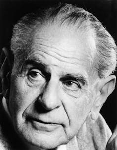 A black and white portrait of Karl Popper