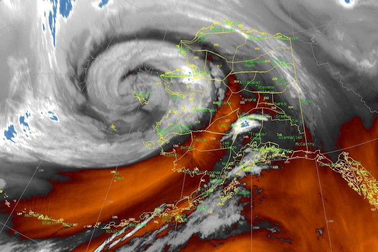 The typhoon, with its swirling clouds, is nearly the size of Alaska itself