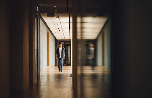 Student walking down a corridor.
