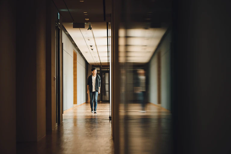 Student walking down a corridor.