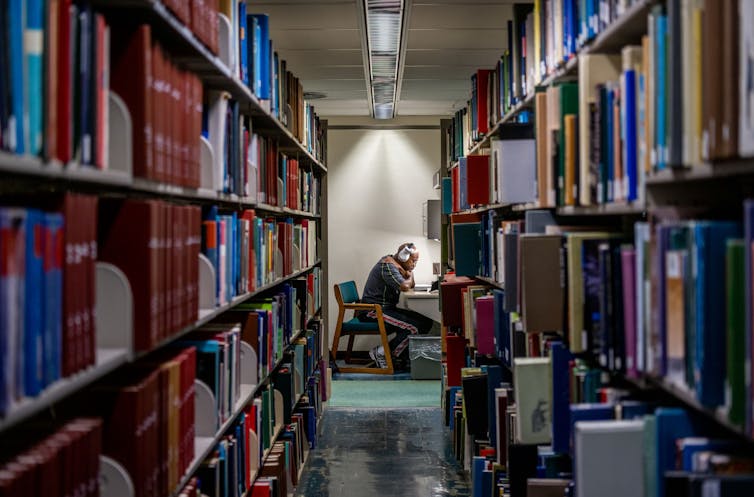 A person reads in a library