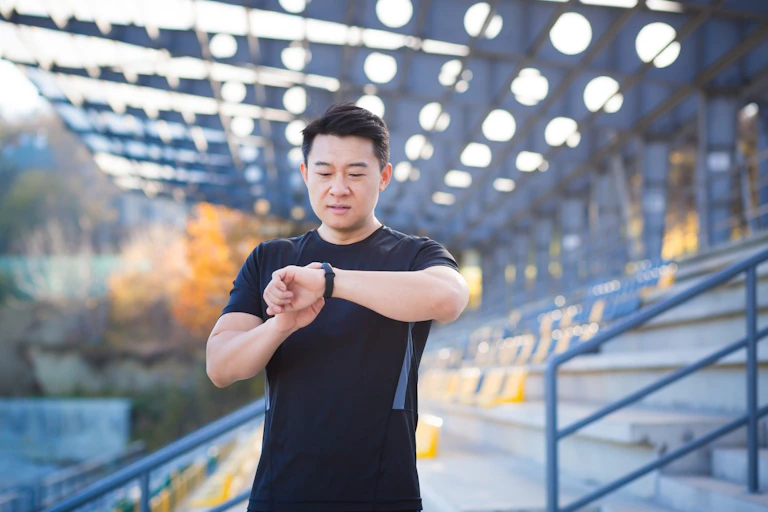 A man checks his smartwatch.
