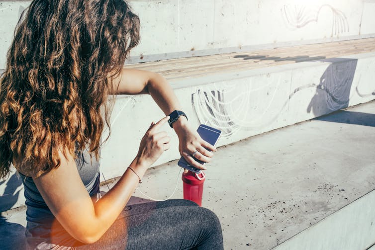 A young woman using her smartwatch.