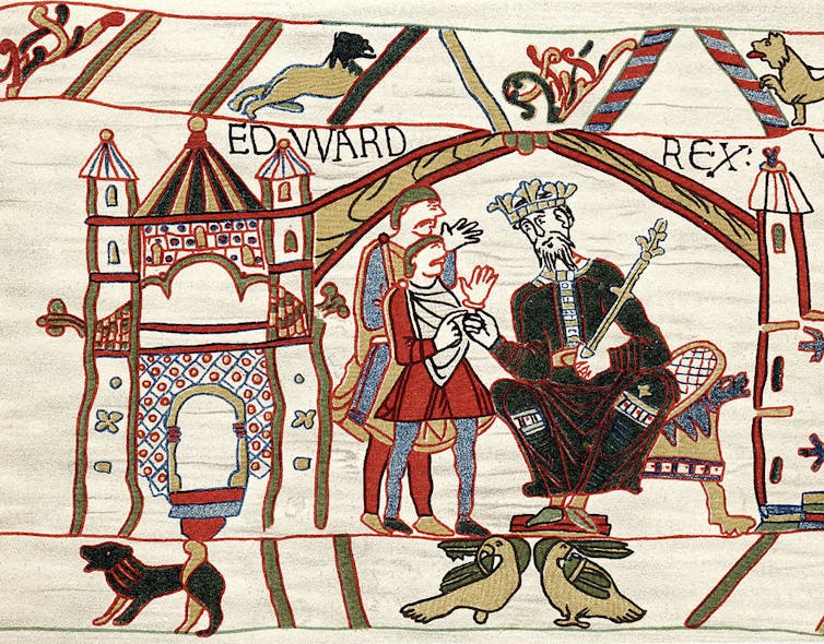 A centuries-old tapestry shows a king on a throne talking with two men on the left.