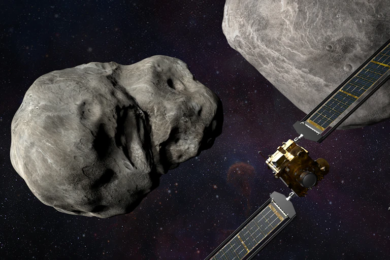 A large spacecraft and a smaller satellite approaching an asteroid in space.