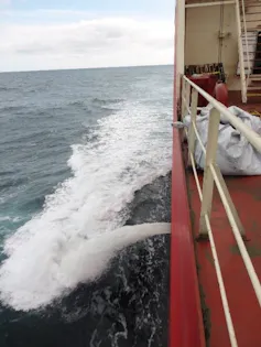 Ship discharging its ballast water at sea.